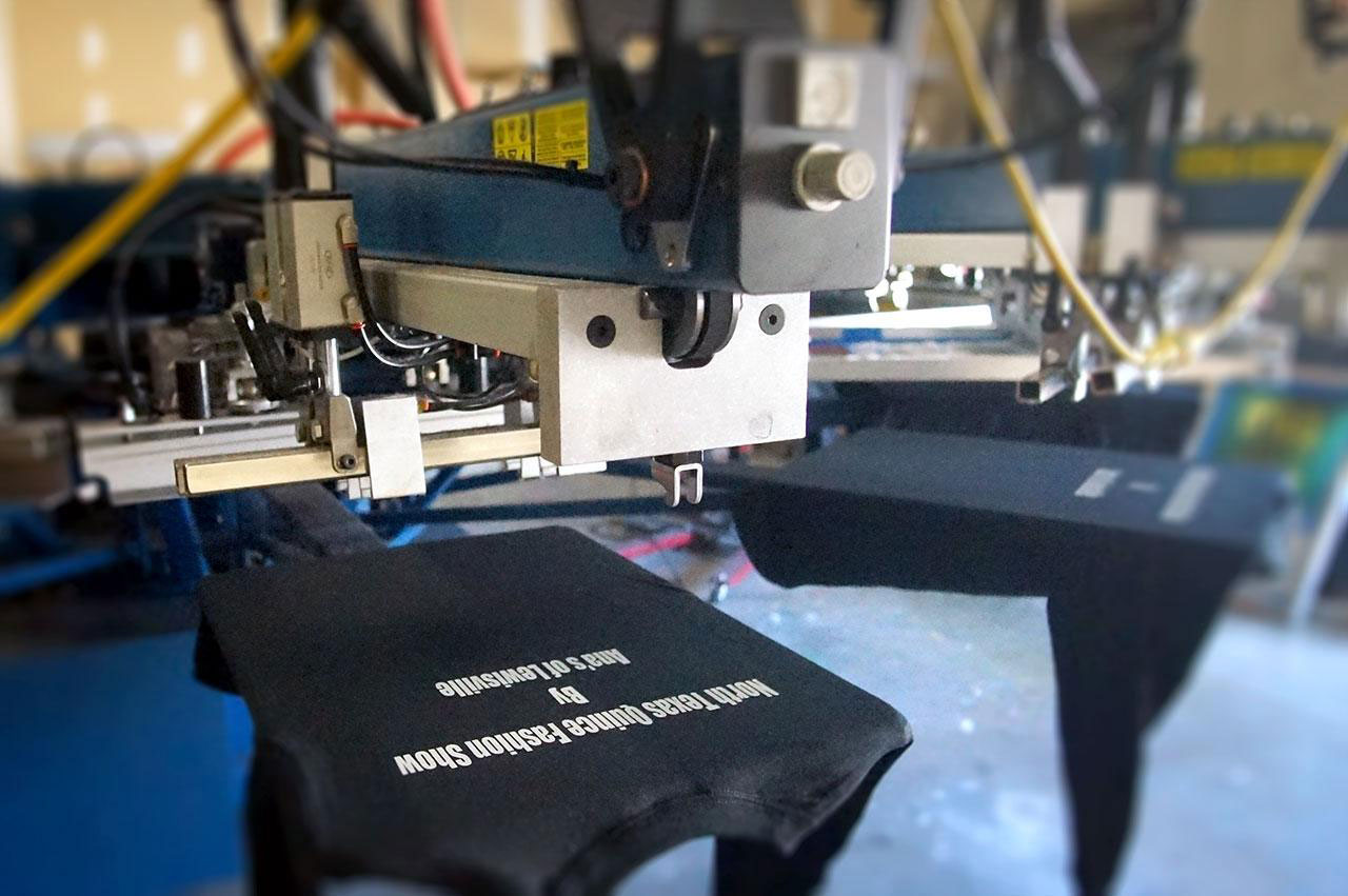 screen printing press machine with a black long sleeve shirt on the press